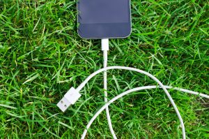 Black Ipod Touch and Cable on Grass